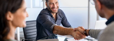 How to Improve Your Chances of Loan Approval; a man smiling shaking someone's hand