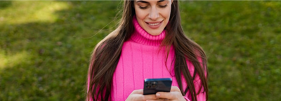 7 Simple Money Handling Tips To Follow In 2024; women smiling at phone