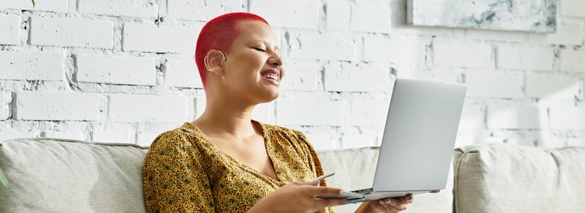 woman on sofa with laptop credit check