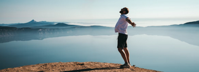 How to Build a Stronger Financial Future; a man standing on top of a mountain