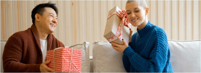 Christmas Gifts On A Budget: 4 Tips To Not Overspend; couple enjoying Christmas morning