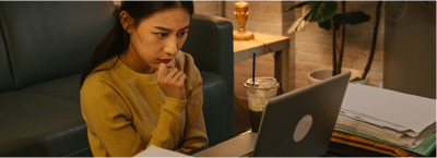 Build your credit score, stressed woman looking at a laptop.