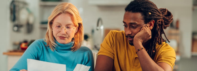 couple looking at their ground rent at kitchen table