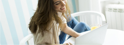 frugal living; a women looking at her laptop