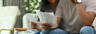 reasonable Borrowing couple stressed with debt bills