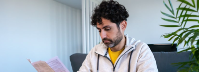 worried man looking at cost of his rising bills