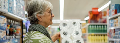 impact of inflation; an old woman shopping groceries