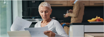 The Impact of Low Credit on Daily Life; a lady looking at documents puzzled