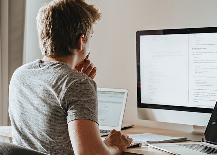 Man looks at finance spreadsheet