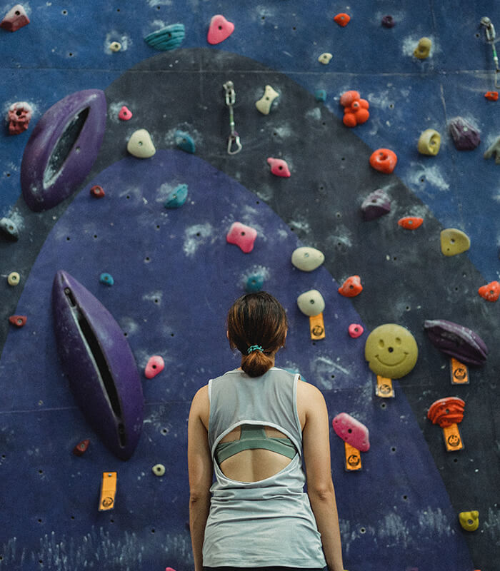 Women looks at challenge of climbing wall